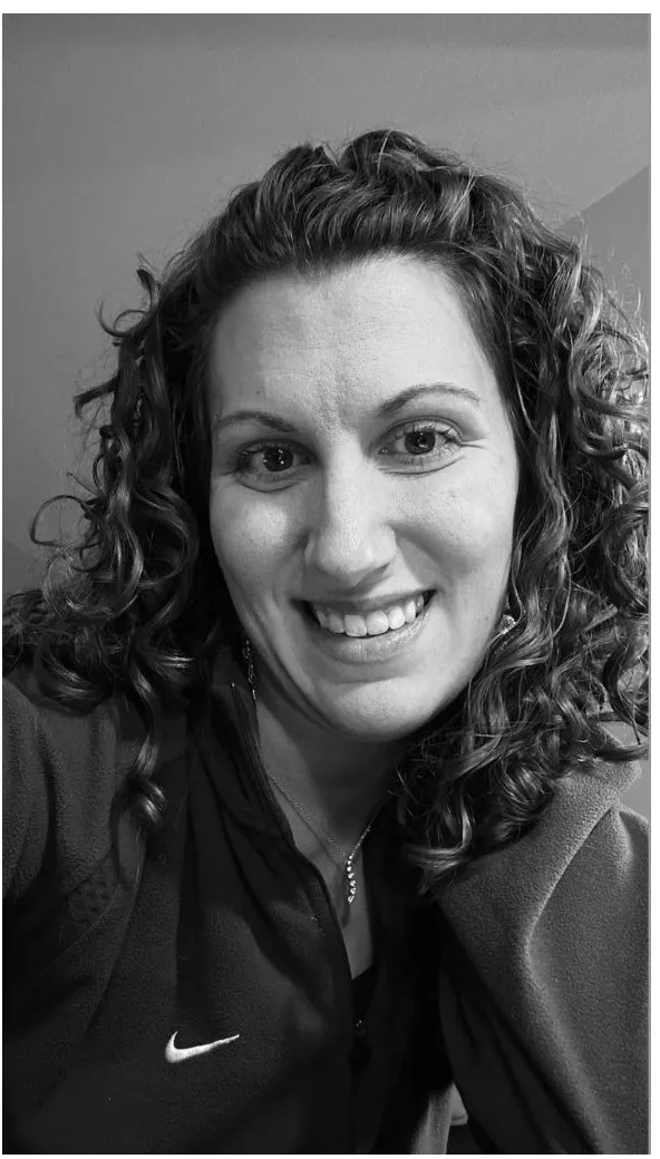 A black-and-white portrait of Korilynn Orth in a jacket