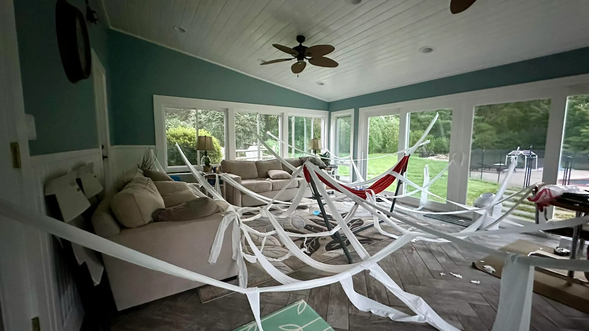 A patio strewn with unrolled toilet paper after a day of kids' play