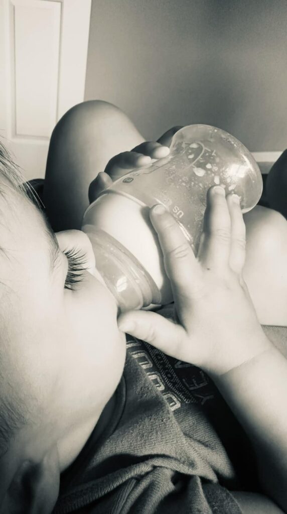 Baby nursing with a bottle