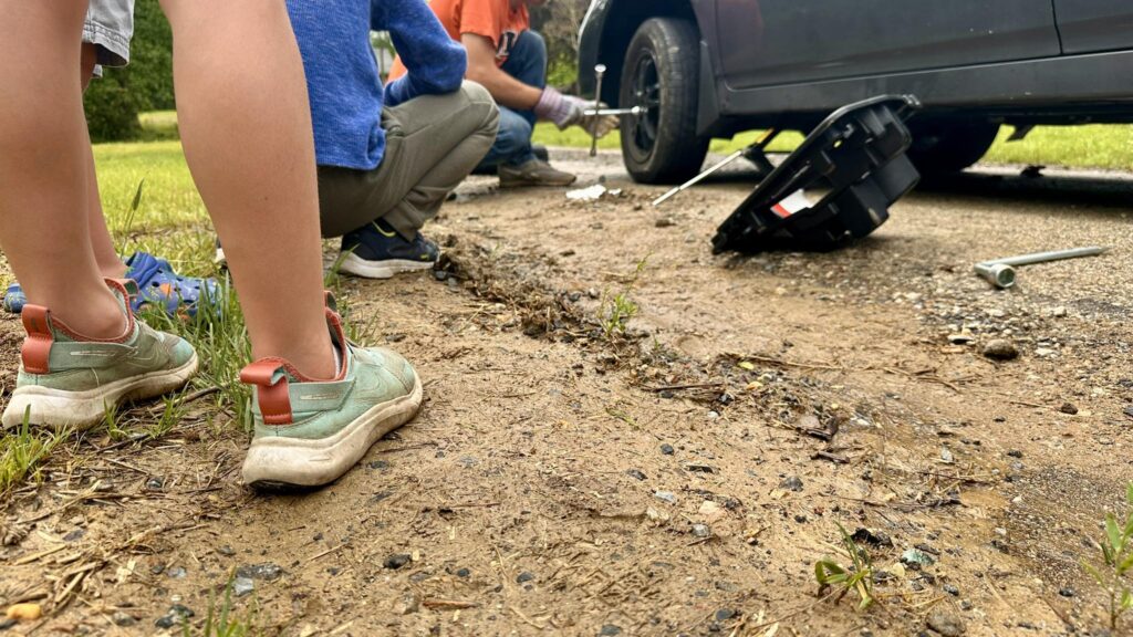 Changing the tire on the minivan
